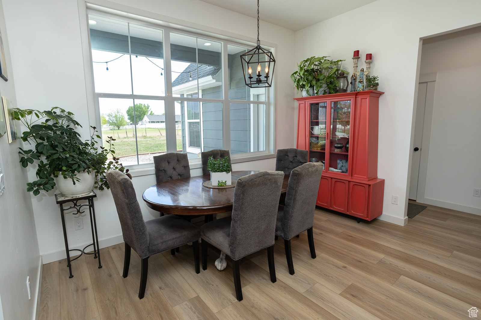 Dining room with a notable chandelier and light hardwood / wood-style floors