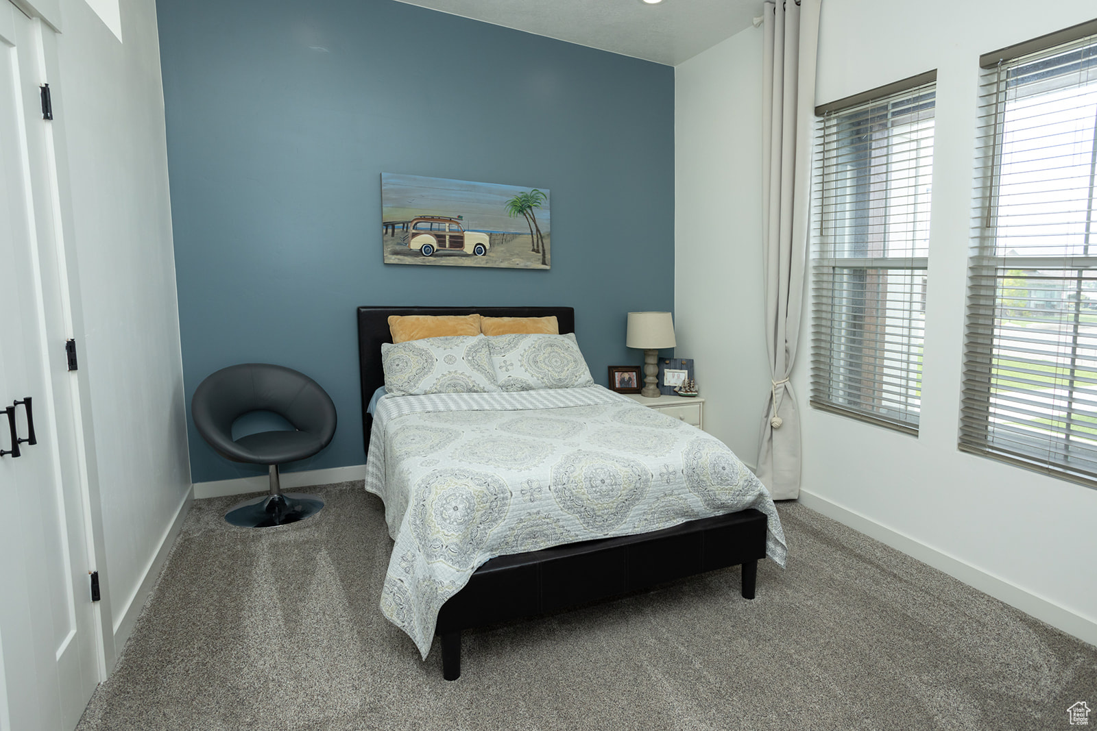 Bedroom with carpet floors and multiple windows