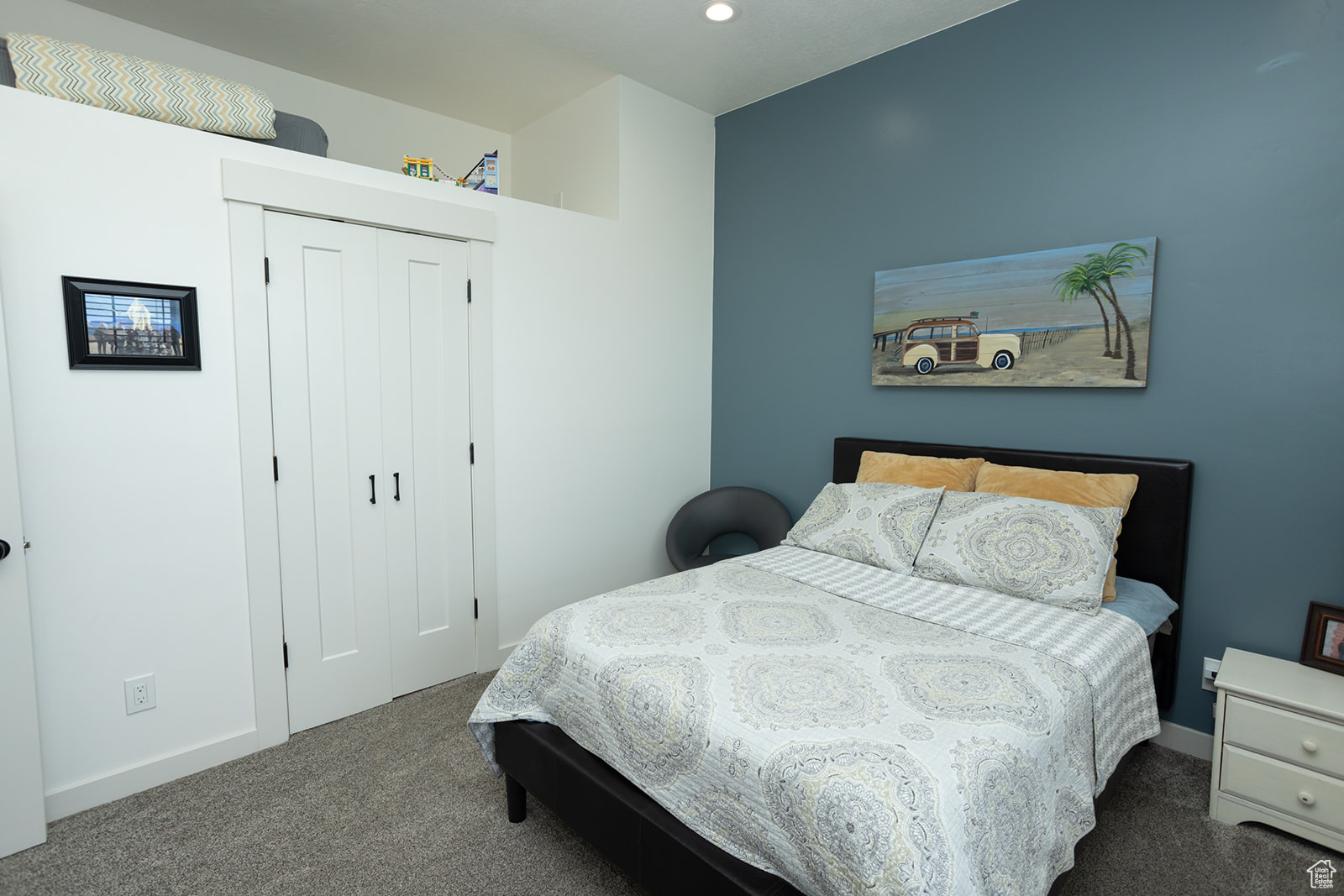 Bedroom with a closet and dark carpet