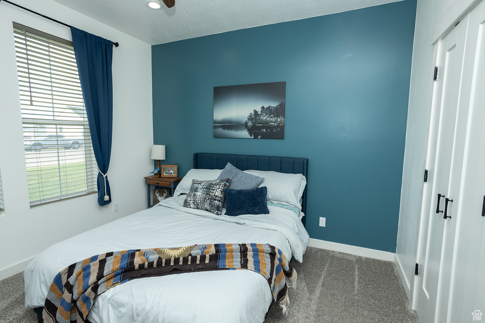 Carpeted bedroom with ceiling fan