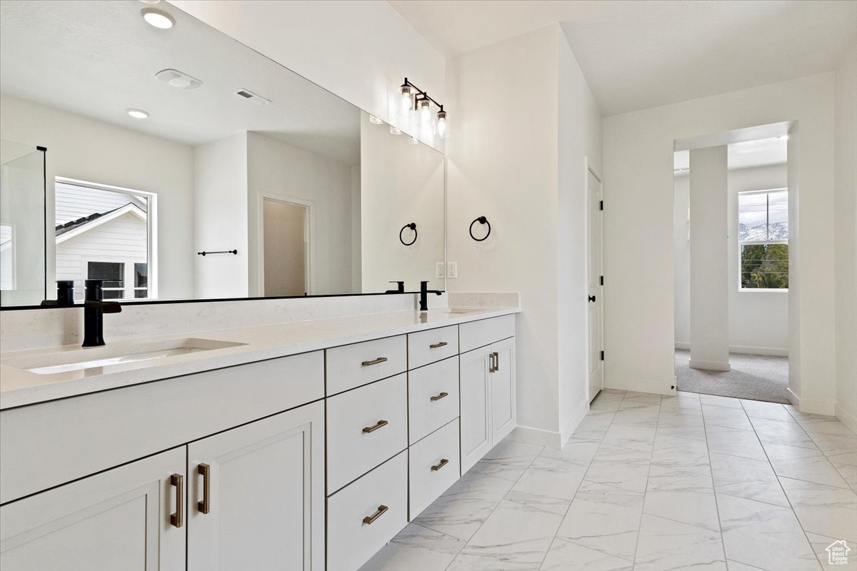 Bathroom featuring dual vanity and tile patterned floors