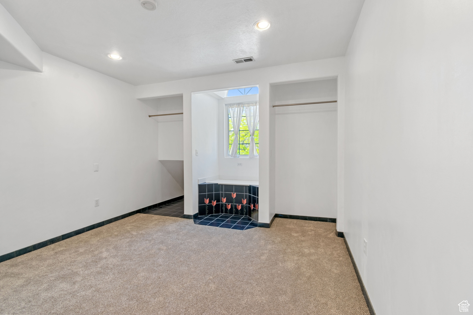 Unfurnished bedroom featuring a closet and carpet floors