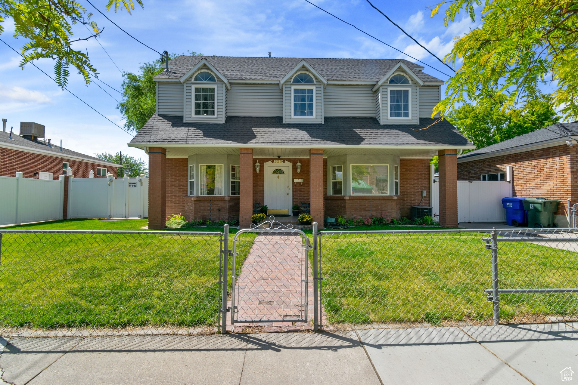 View of front facade featuring central AC and a front lawn