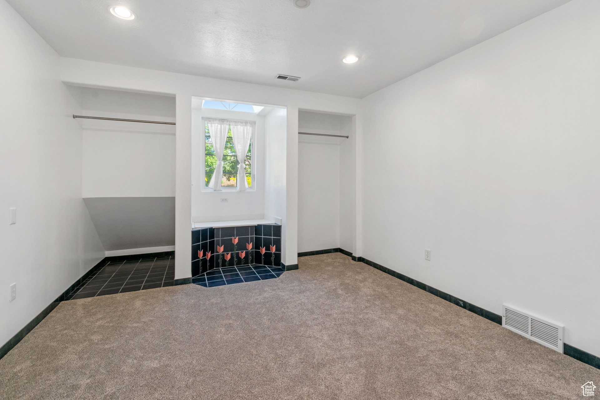 Unfurnished bedroom with a closet and dark carpet