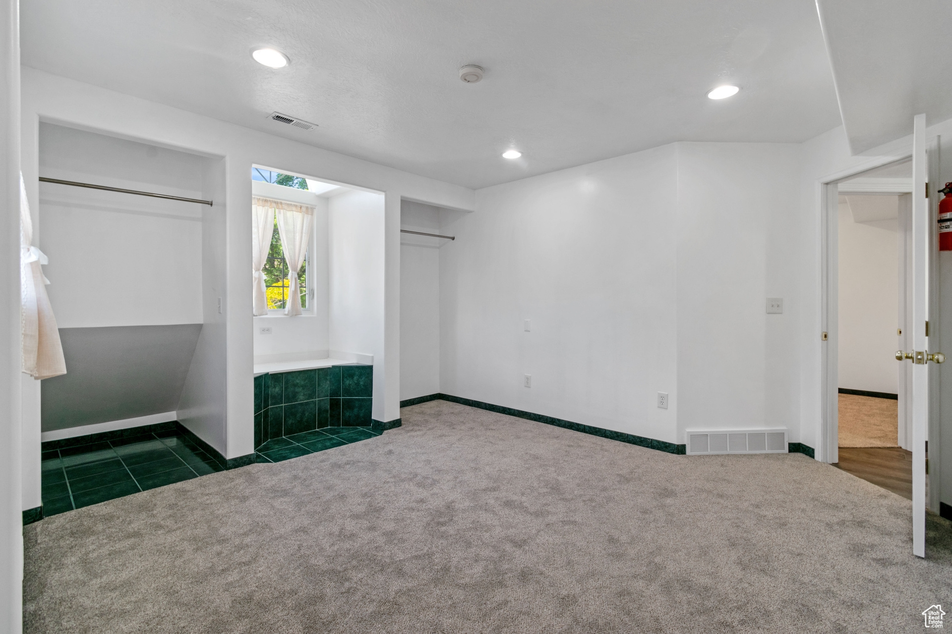 Unfurnished bedroom with tile flooring and a closet