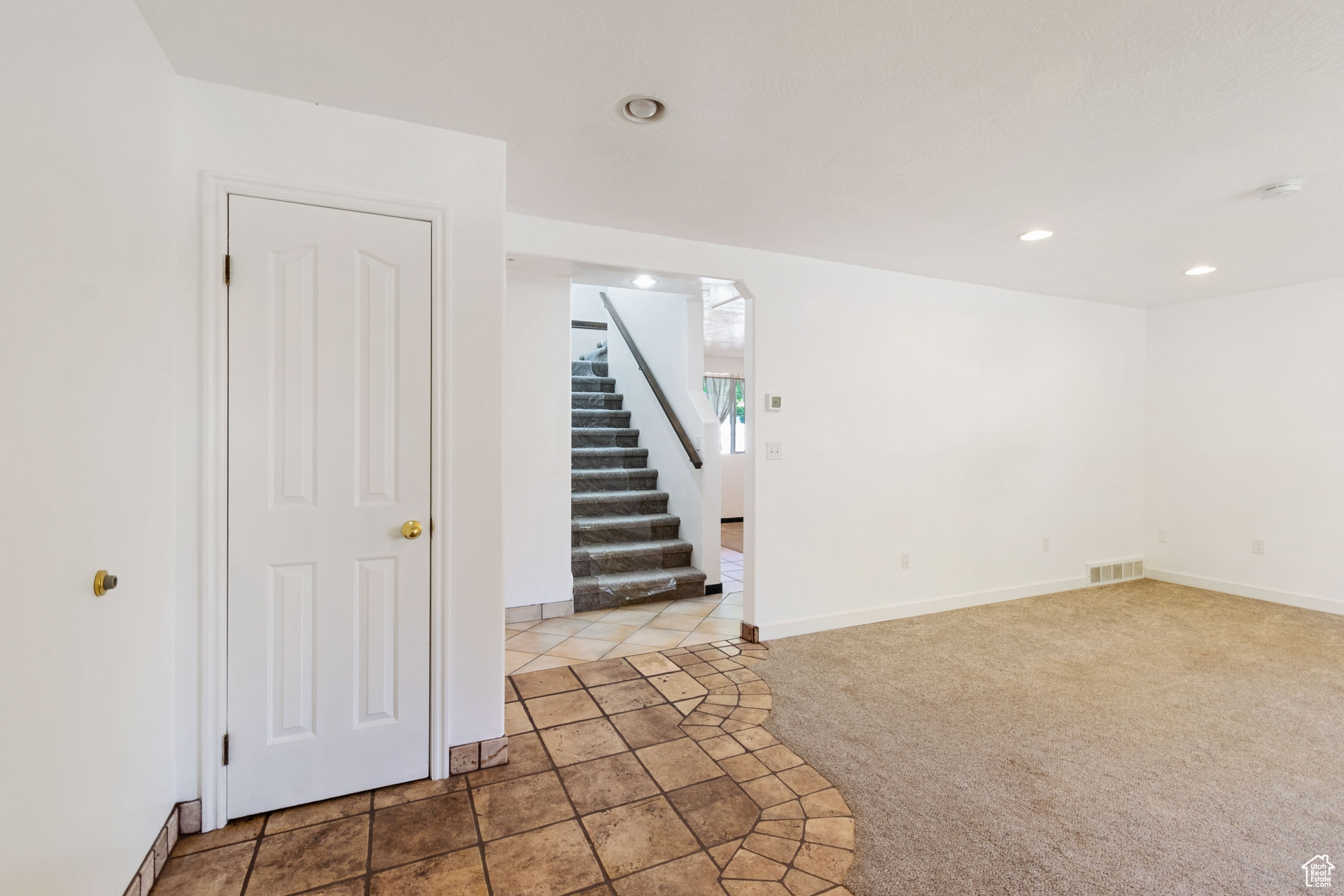 Unfurnished room with light carpet