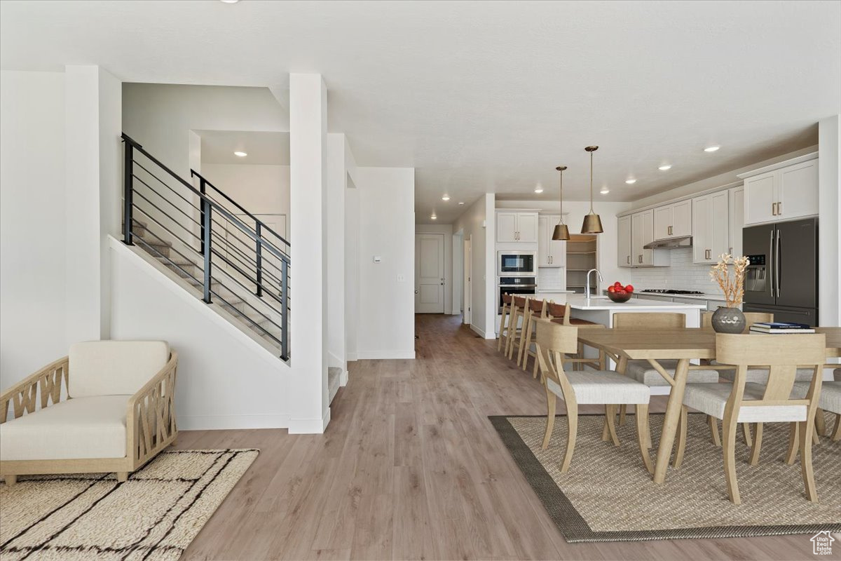 Dining area featuring sink and light hardwood / wood-style floors