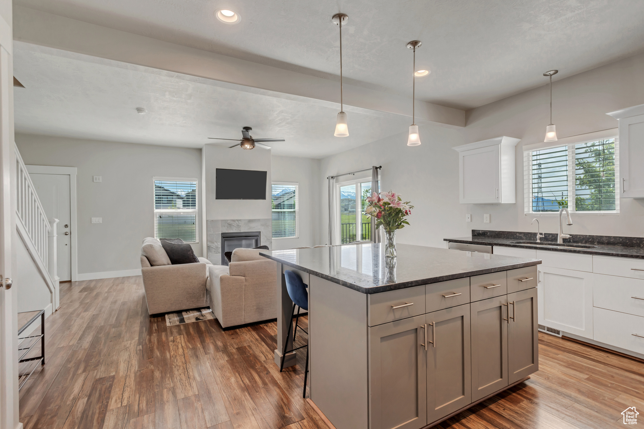 Kitchen with a center island, a fireplace, plenty of natural light, and beamed ceiling