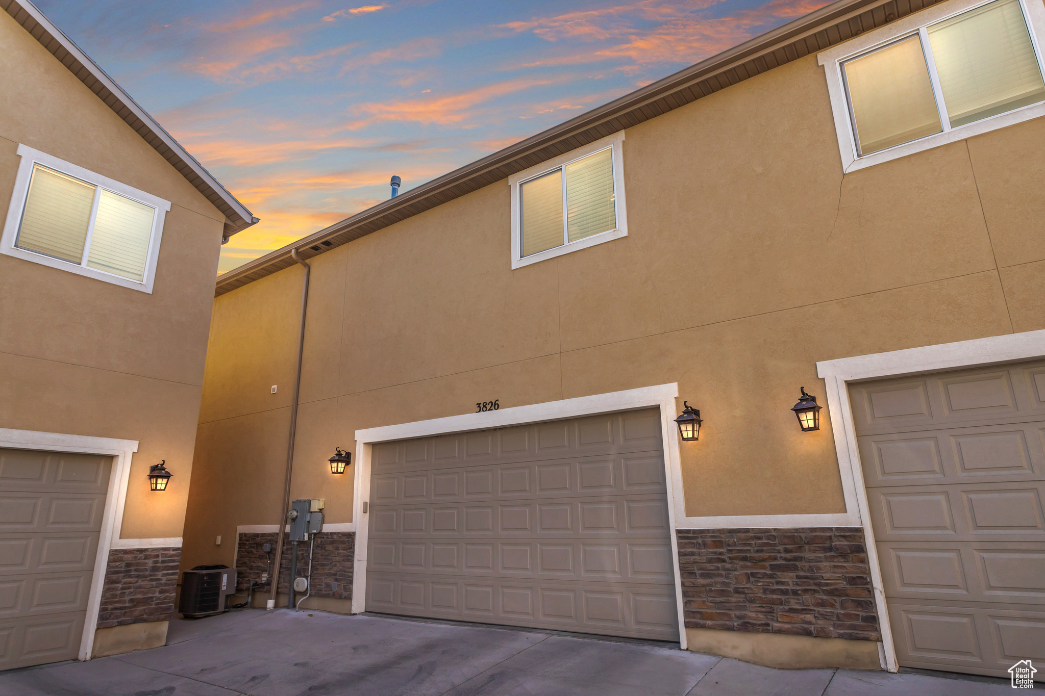 View of front of property featuring a garage and central AC