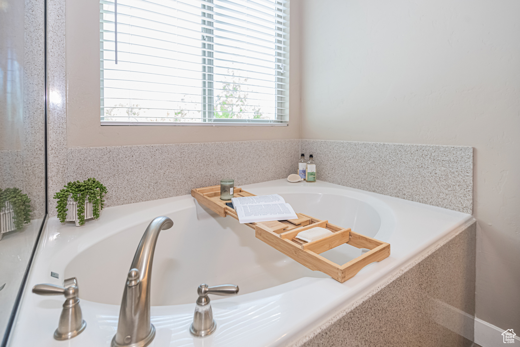 Bathroom with a wealth of natural light and a tub