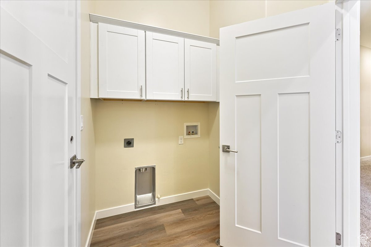 Laundry room with carpet, washer hookup, electric dryer hookup, and cabinets