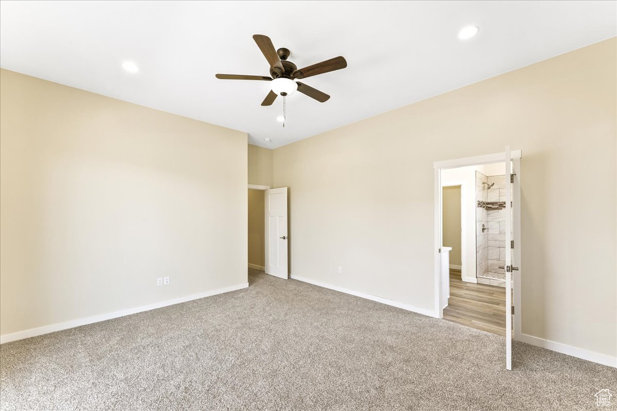 Unfurnished bedroom featuring carpet floors and ceiling fan