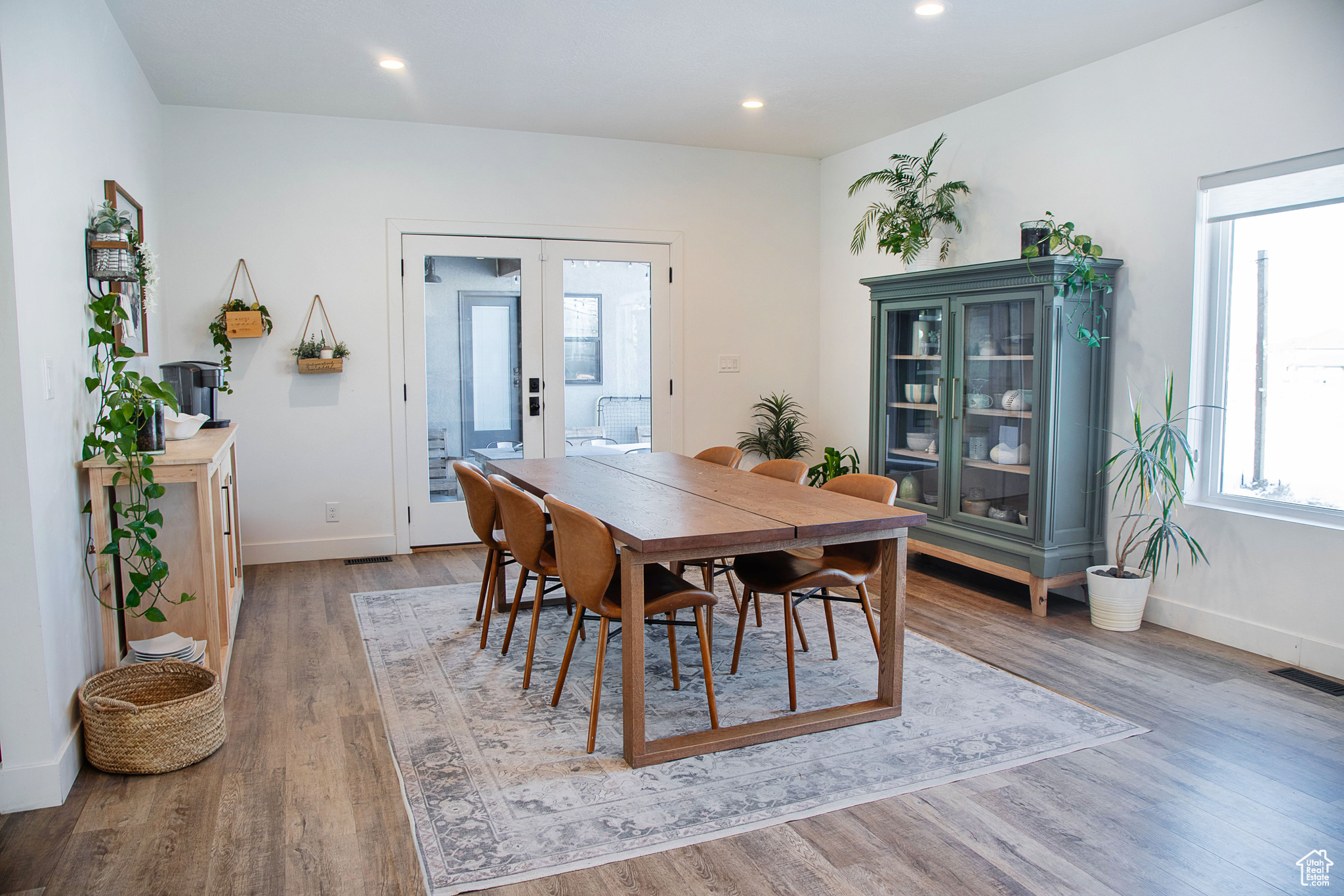 Dining area with hardwood / wood-style flooring and french doors