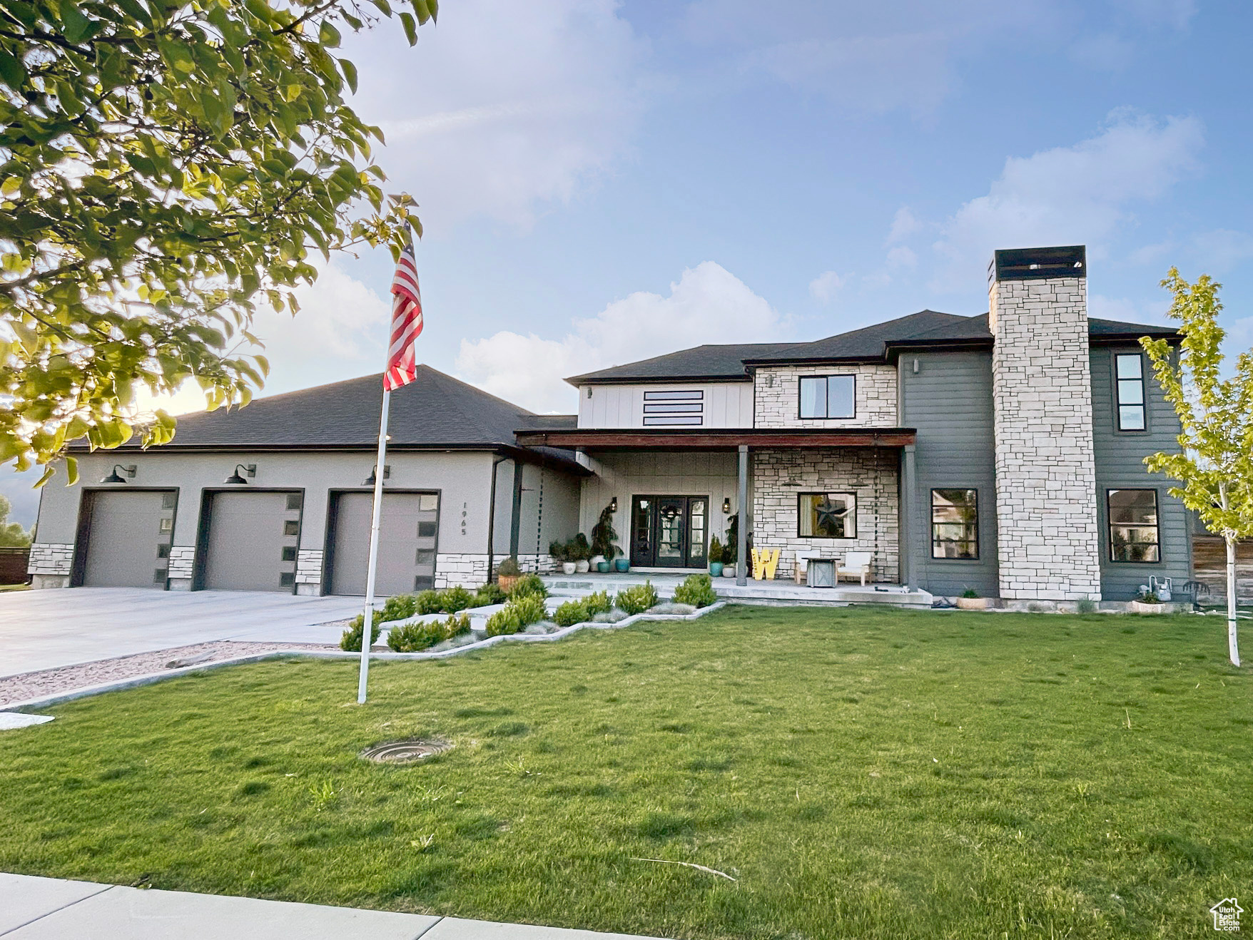 View of front of house with a front yard and a garage