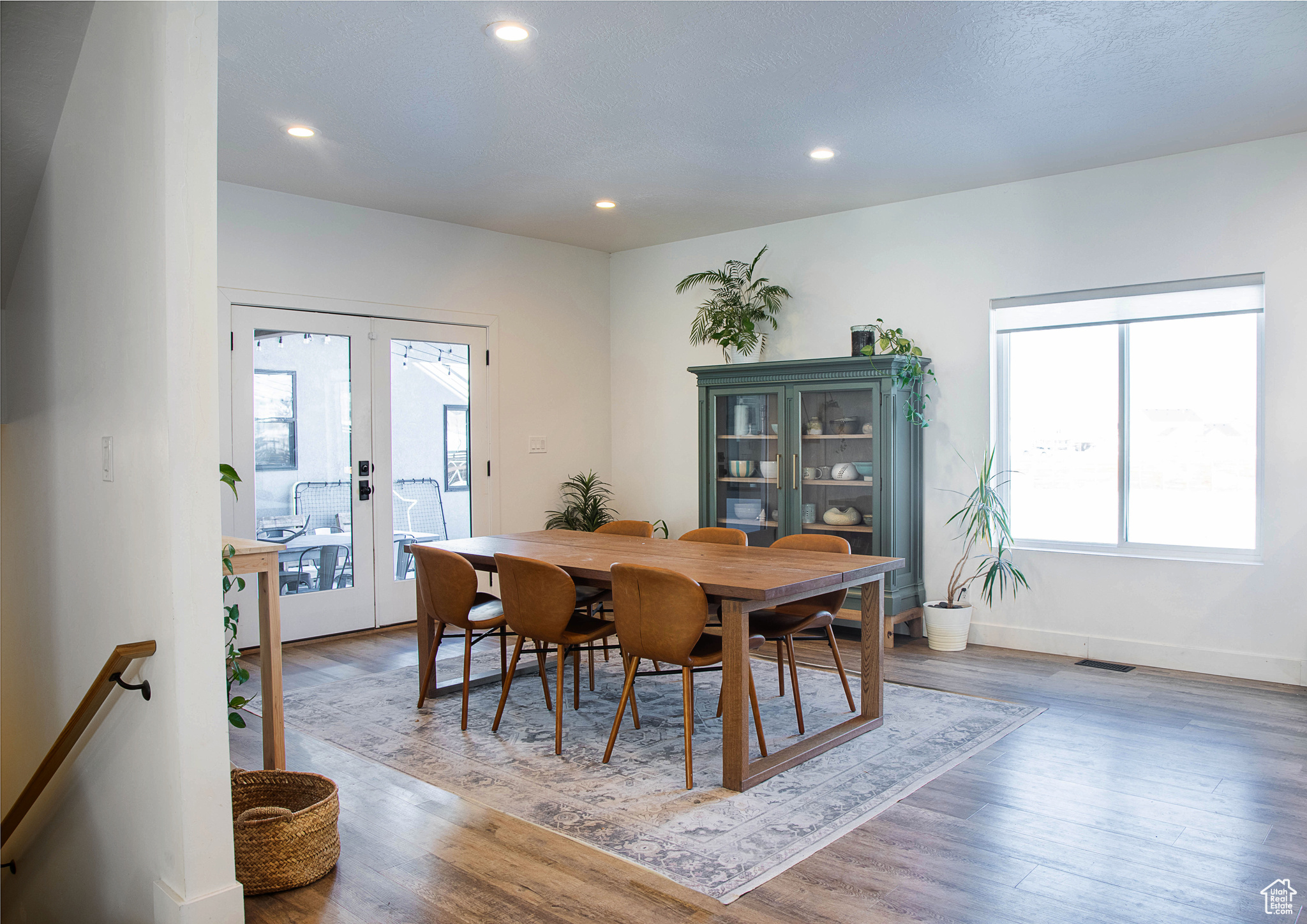 Dining area featuring hardwood / wood-style flooring, french doors, and a healthy amount of sunlight