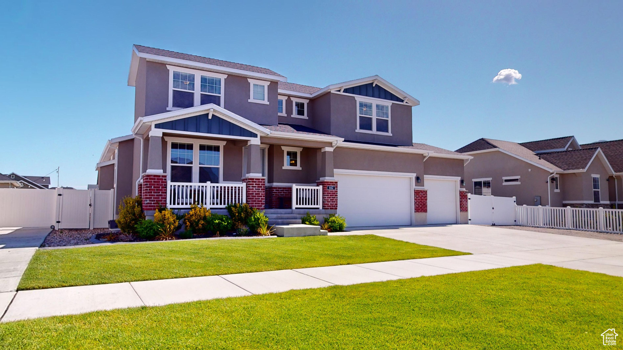 Craftsman inspired home with a porch, a garage, and a front lawn