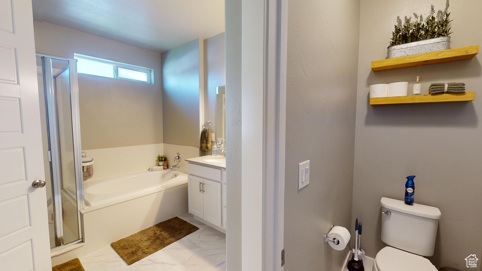 Full bathroom featuring independent shower and bath, vanity, toilet closet, and vinyl tile floors