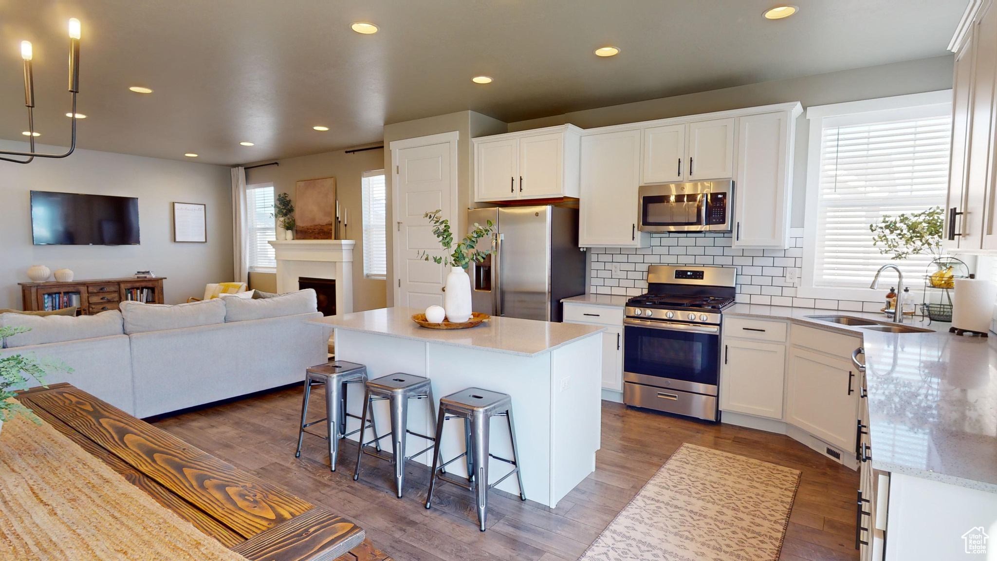 Kitchen featuring sink, a center island, stainless steel appliances, and white cabinetry