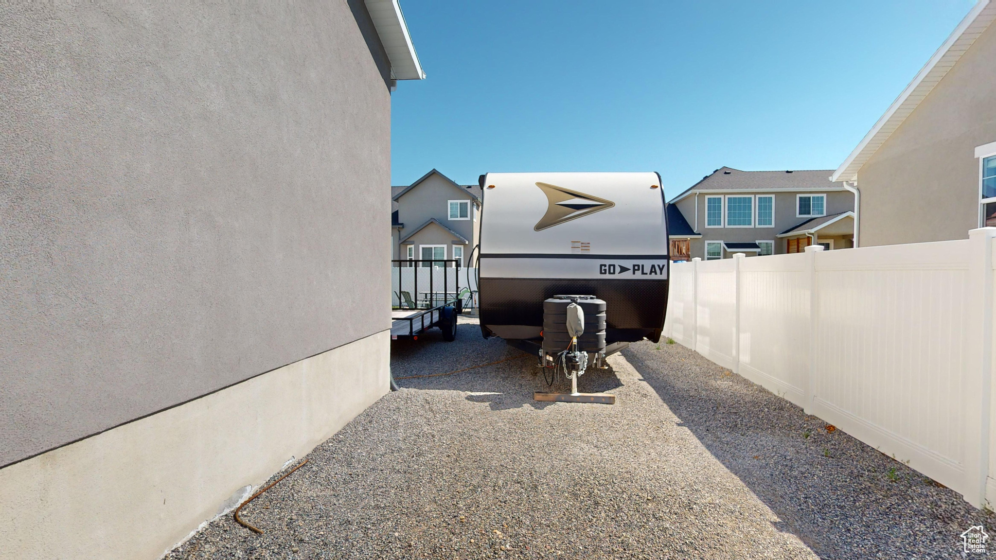 Side yard with RV parking behind the gate.