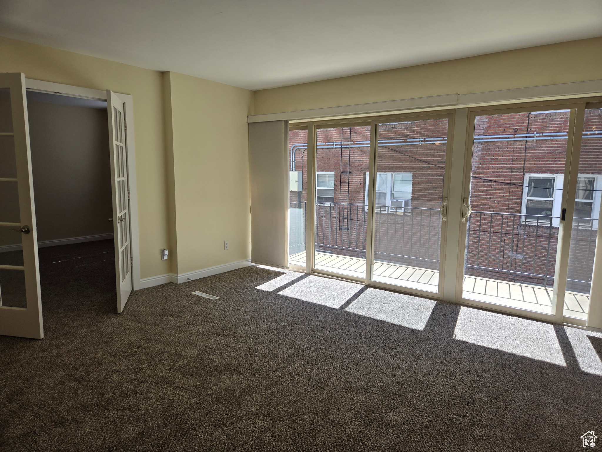 Unfurnished room with dark colored carpet