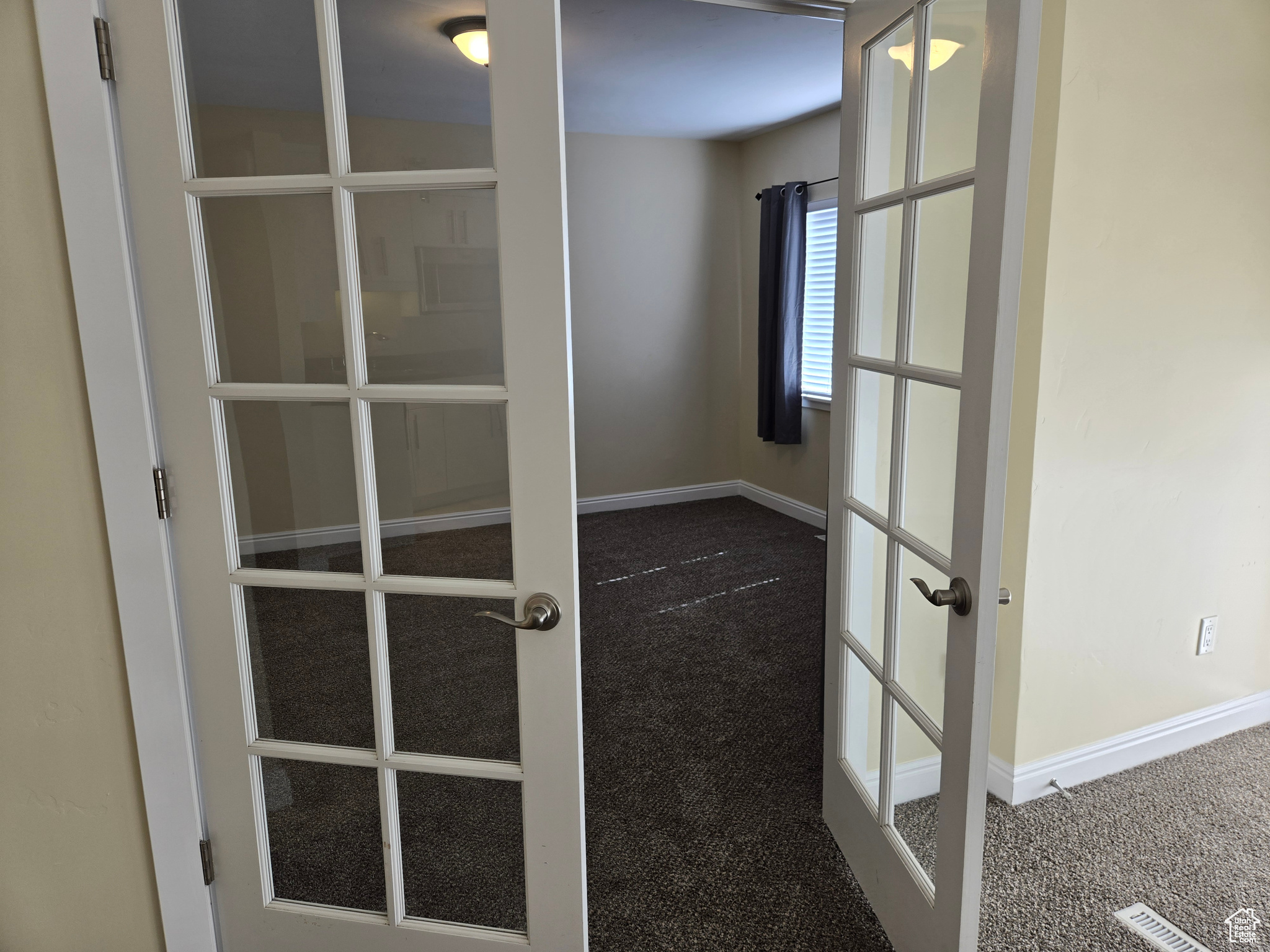 Details with carpet floors and french doors