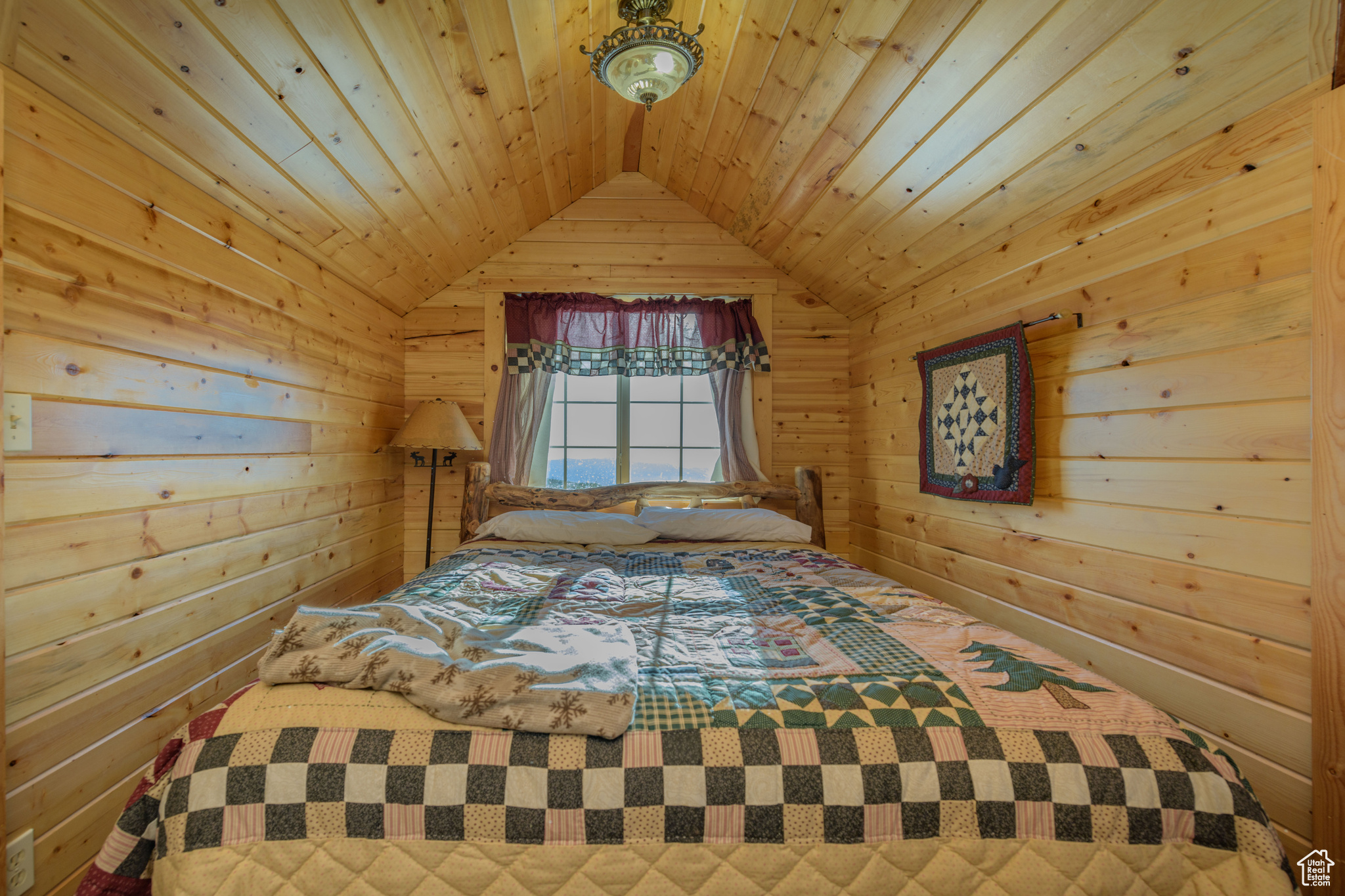 Bedroom with lofted ceiling and wood ceiling