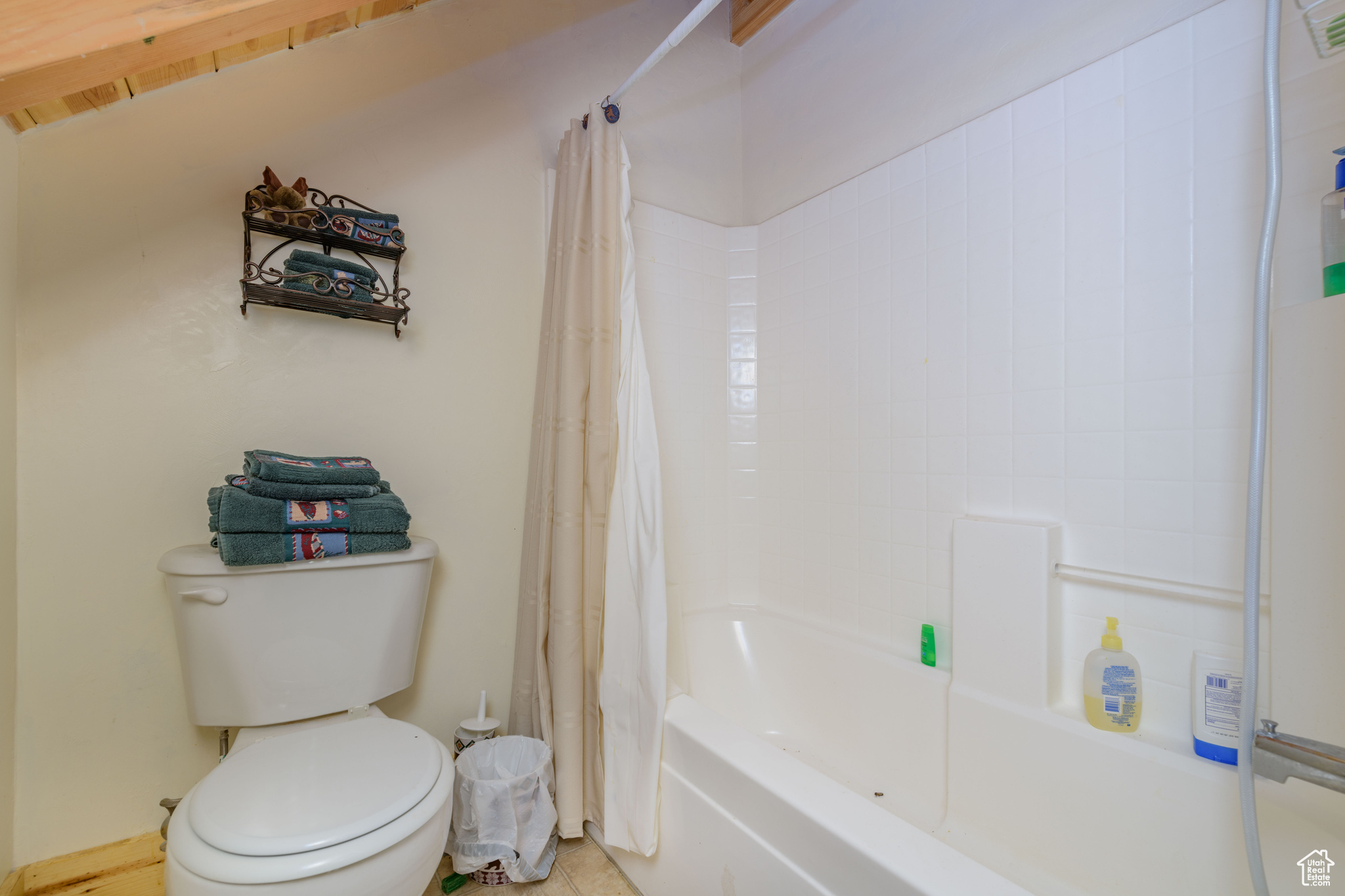 Bathroom featuring shower / bath combo and toilet