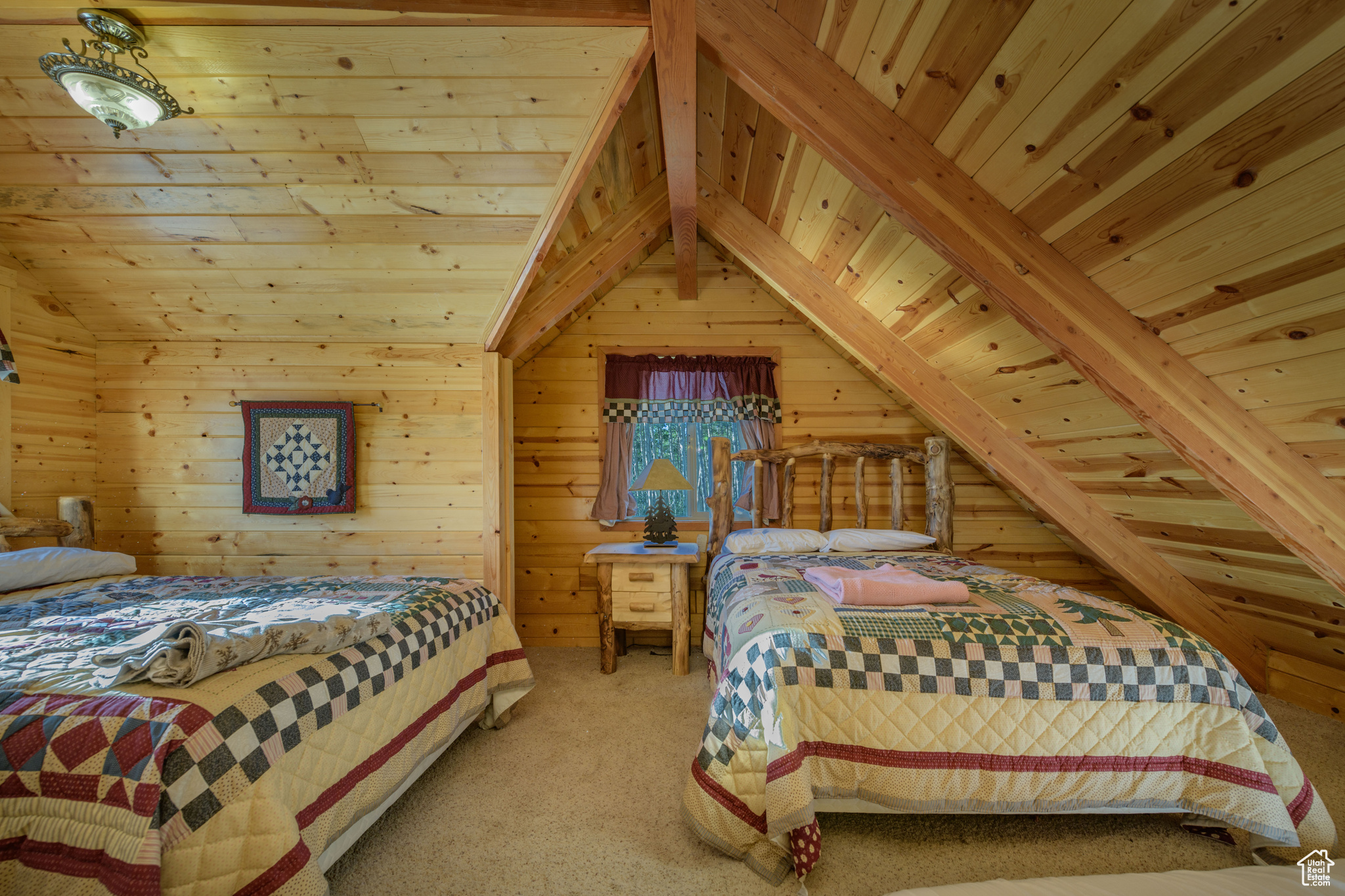 Carpeted bedroom with wooden ceiling, lofted ceiling with beams, and wooden walls