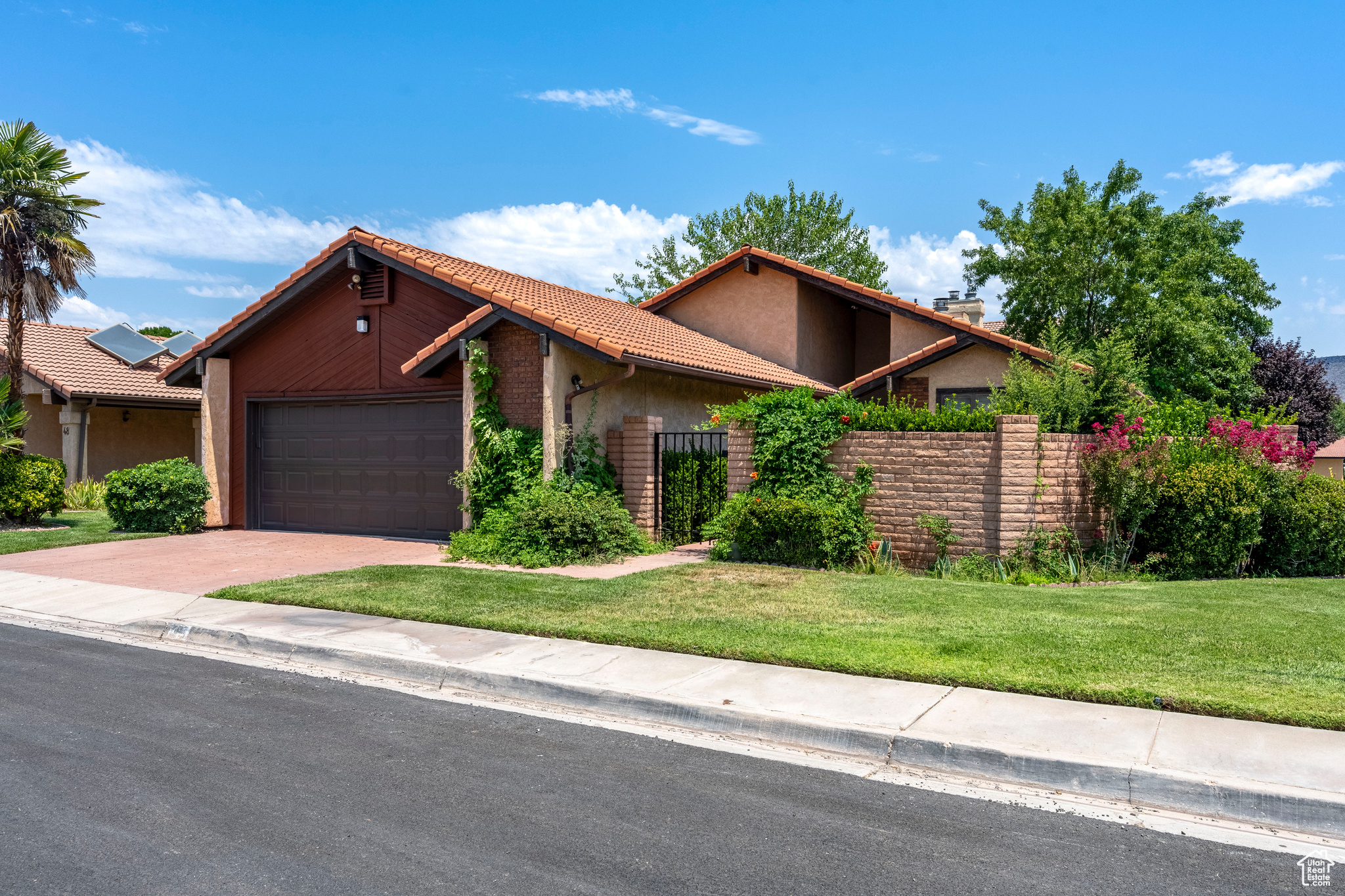 View of front of property with a garage and a front yard