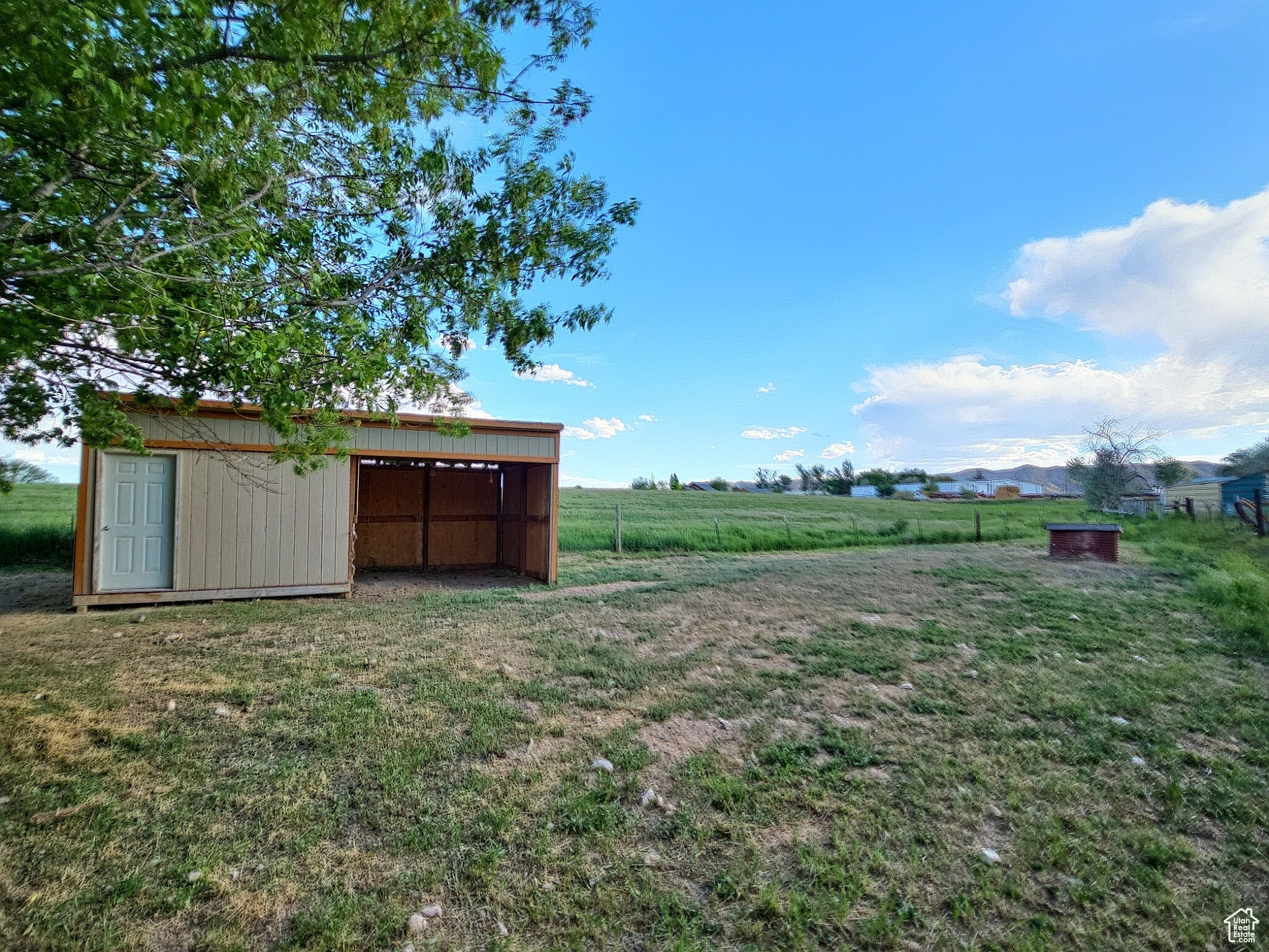 View of yard featuring an outdoor structure and a rural view