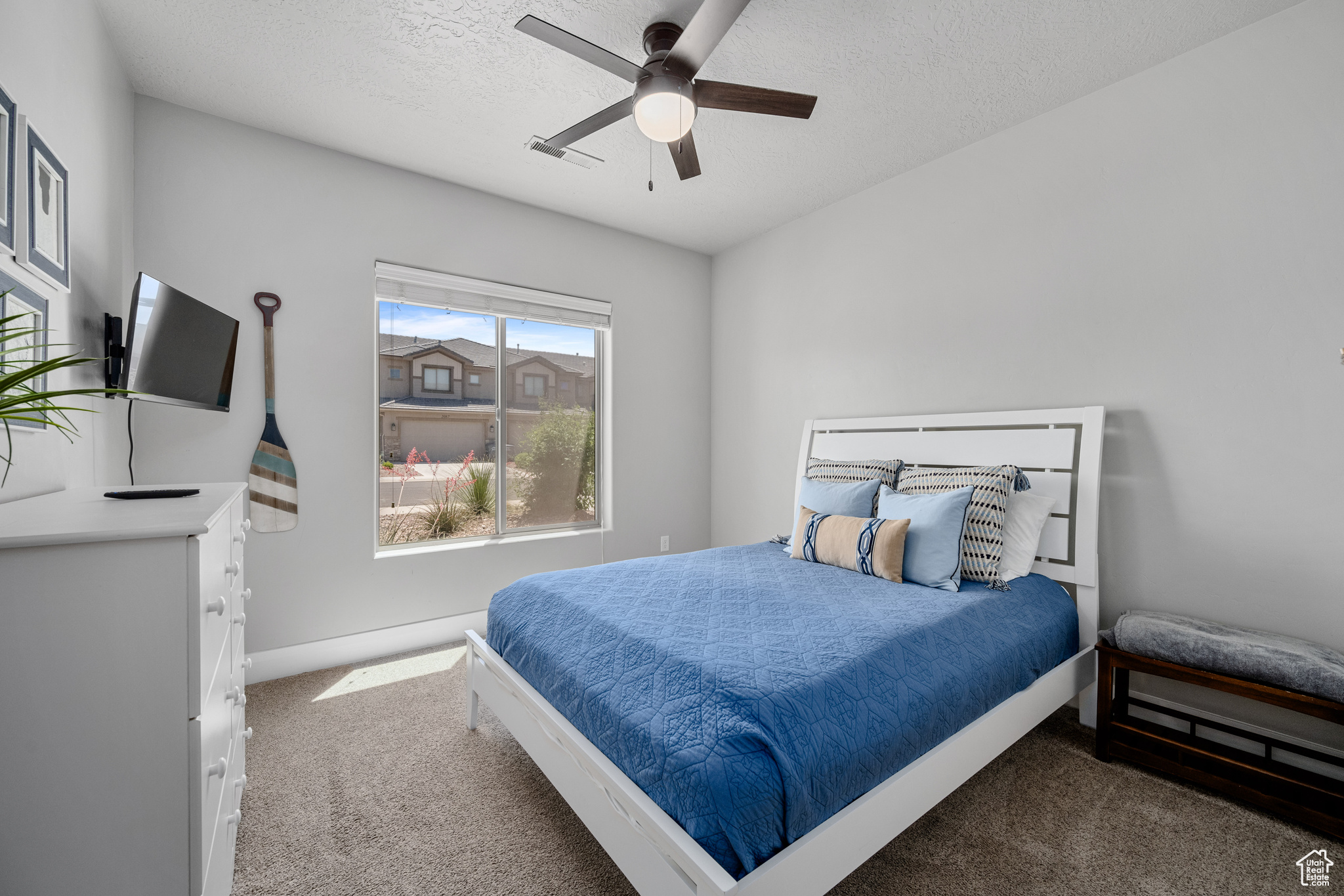 Bedroom featuring carpet flooring, ceiling fan, and a textured ceiling