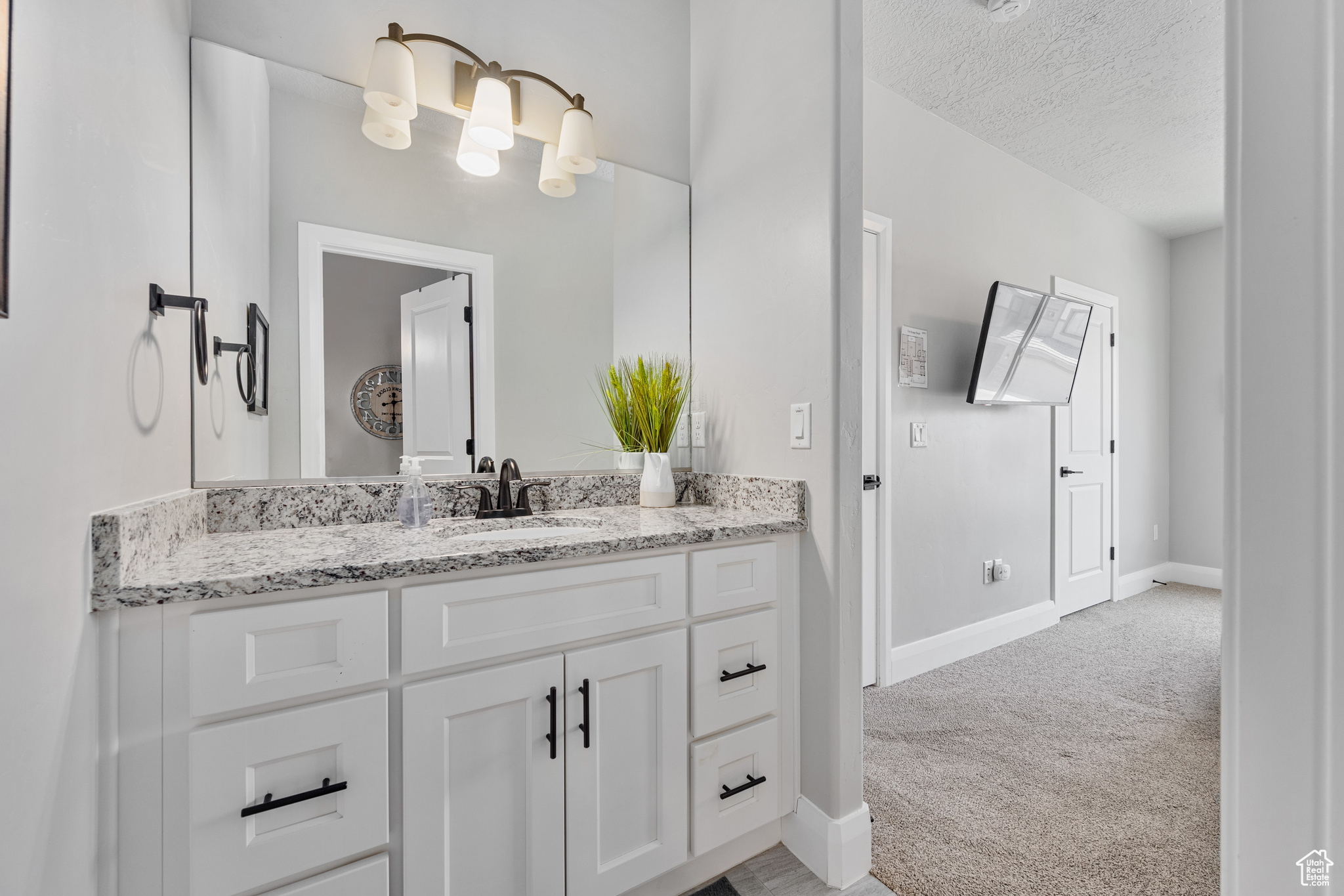 Bathroom featuring a textured ceiling and vanity