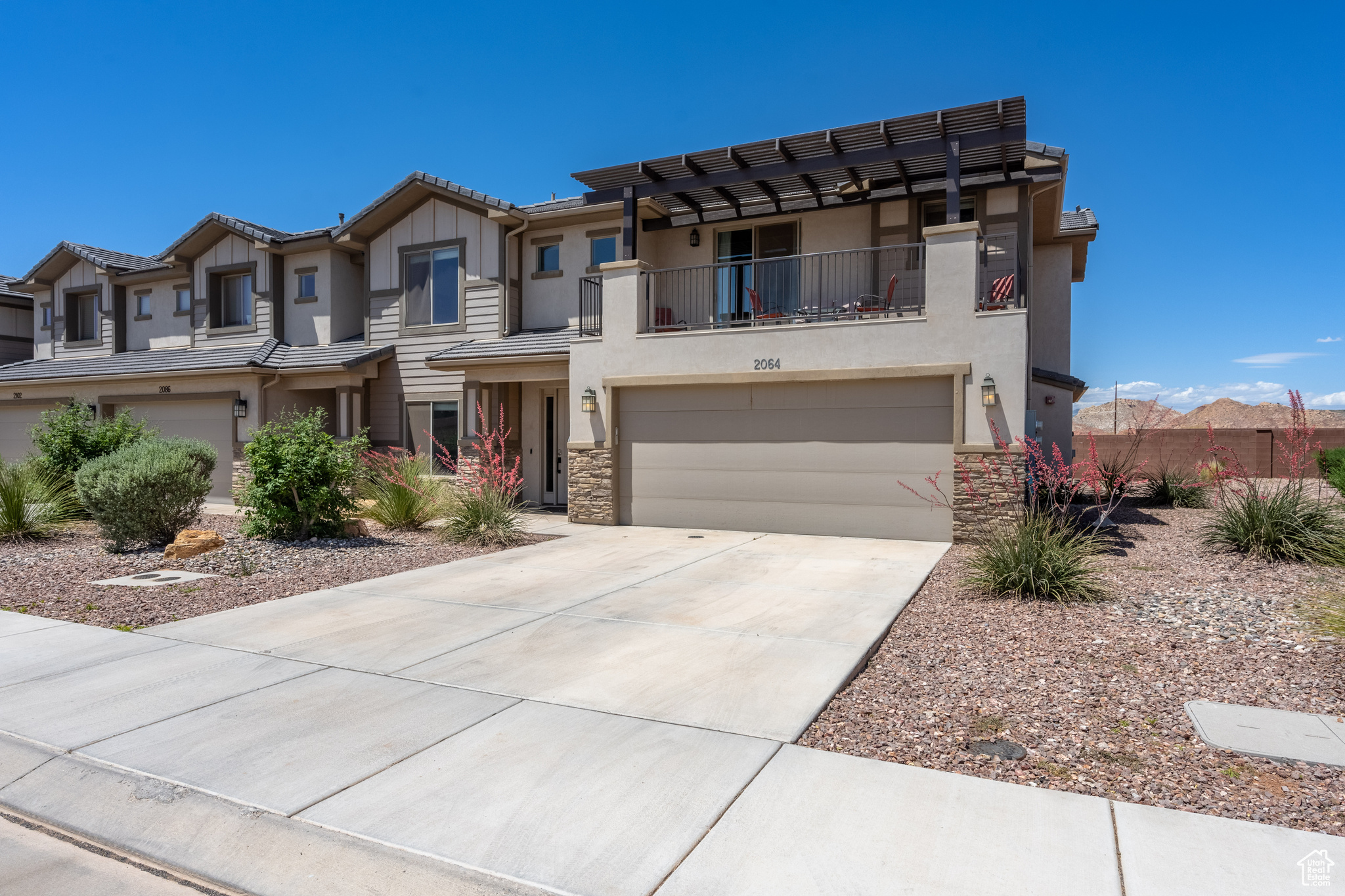 View of property featuring a garage and a balcony