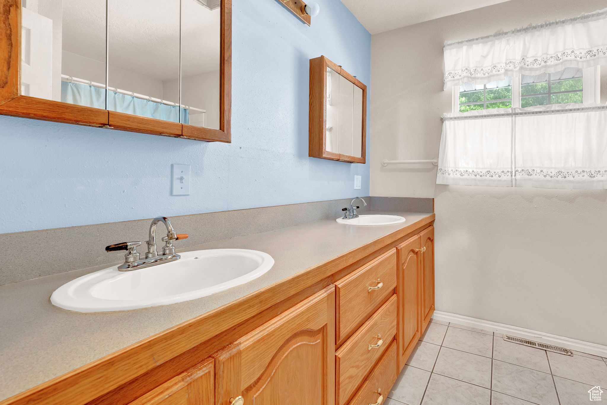 Bathroom with tile patterned flooring and double sink vanity