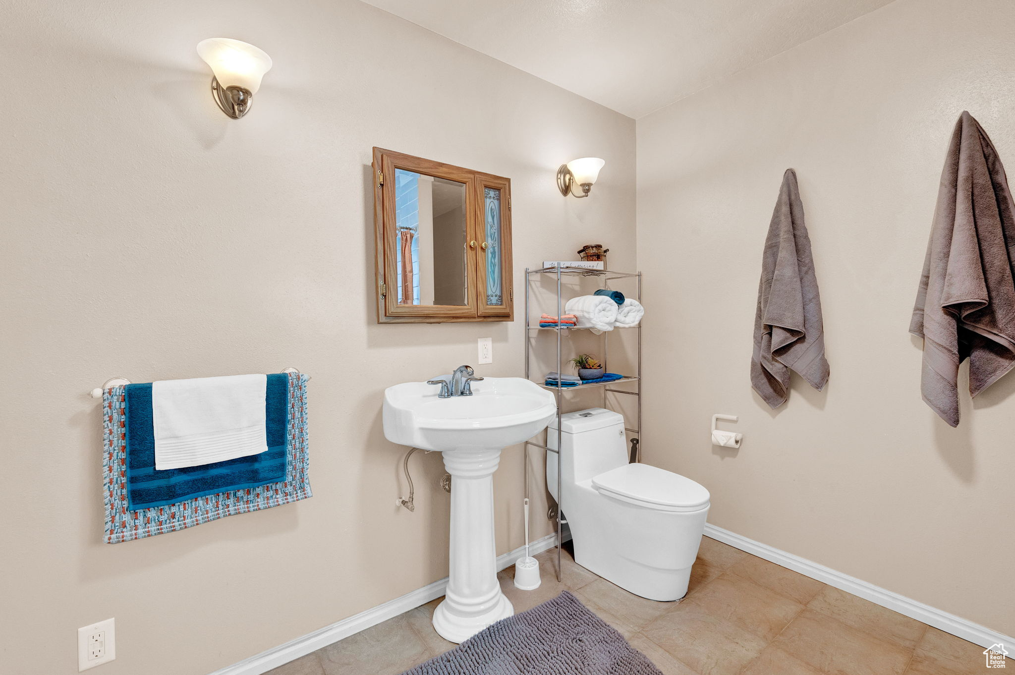 Bathroom with toilet and tile patterned flooring