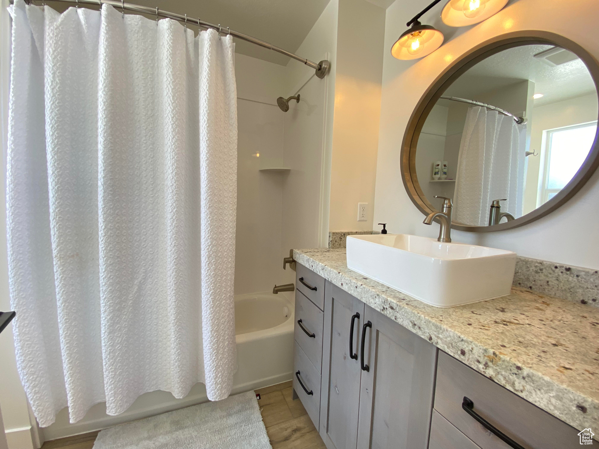 Bathroom with shower / bath combination with curtain, vanity, and tile floors