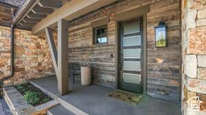 View of exterior entry with covered porch