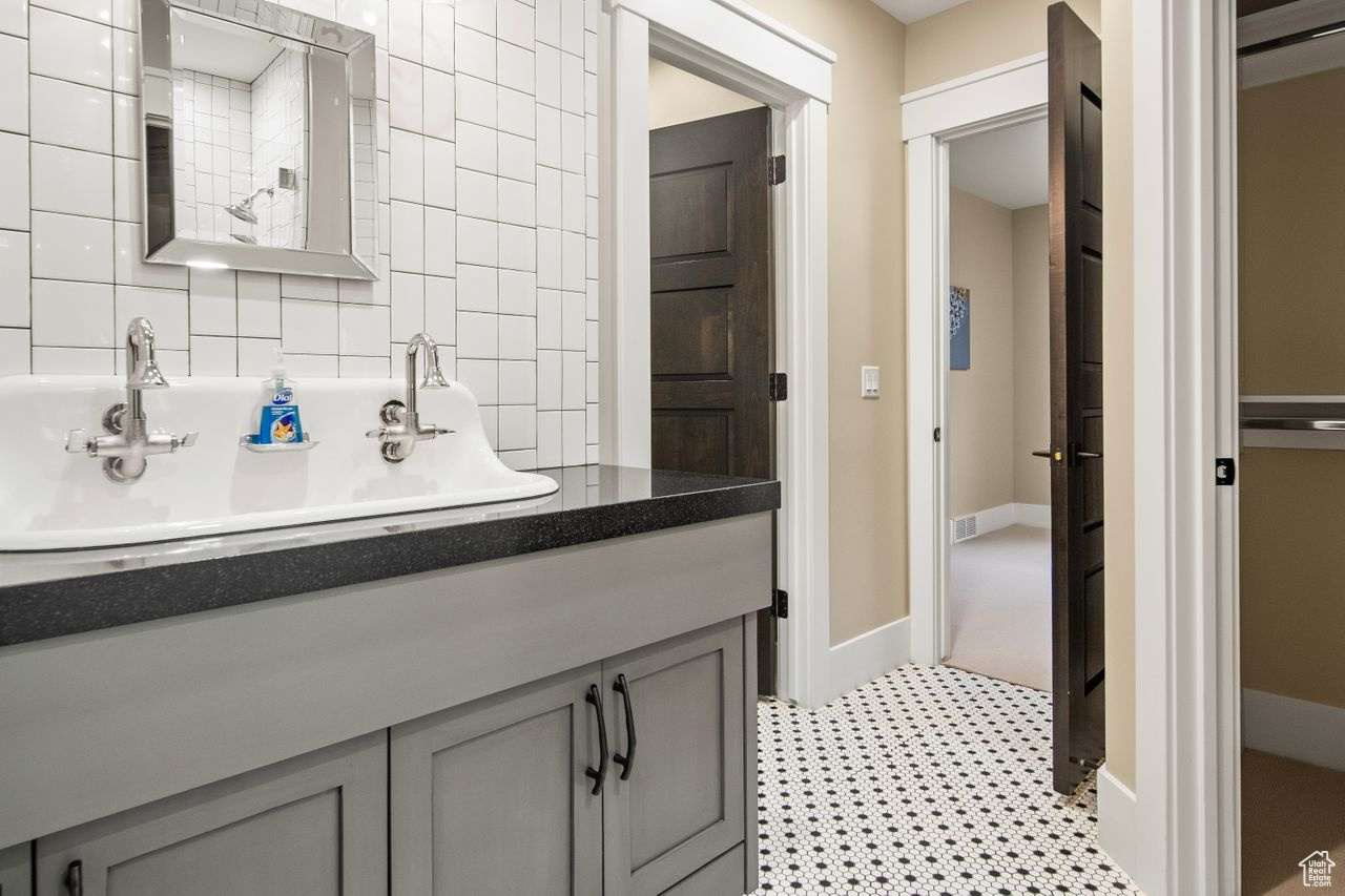 Bathroom with oversized vanity, tile walls, and tile floors