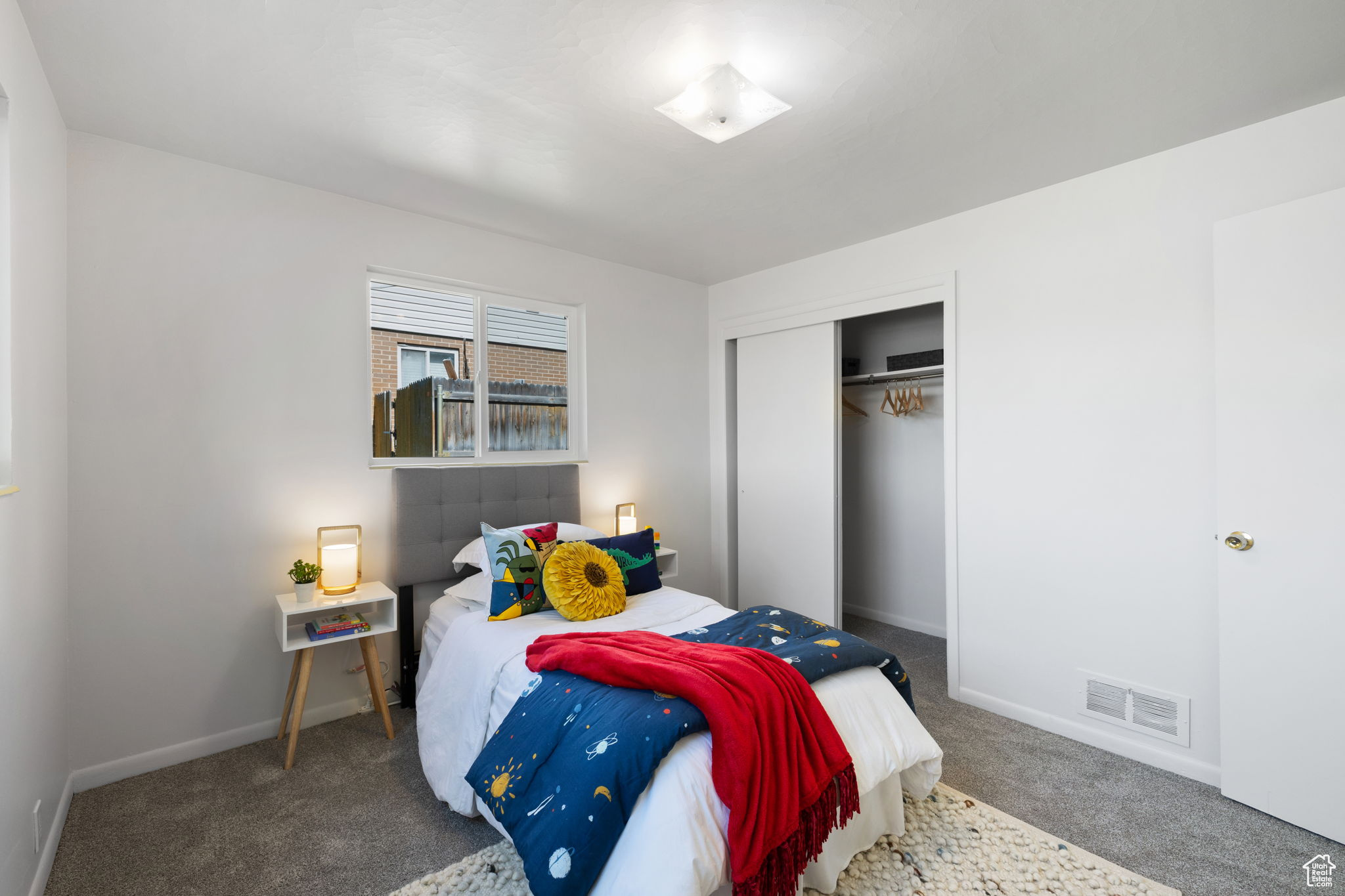 Carpeted bedroom with a closet