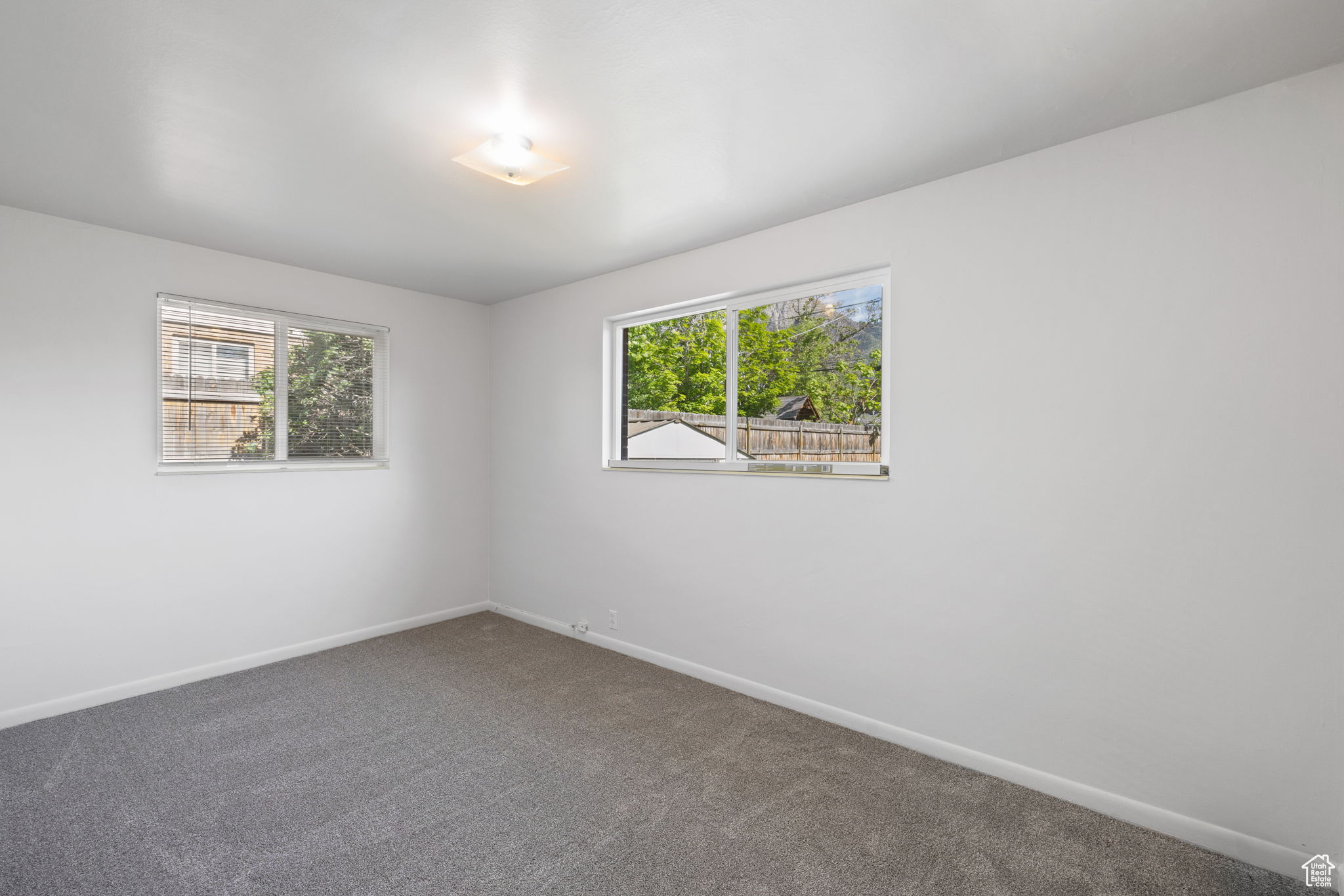 Spare room featuring a healthy amount of sunlight and carpet floors