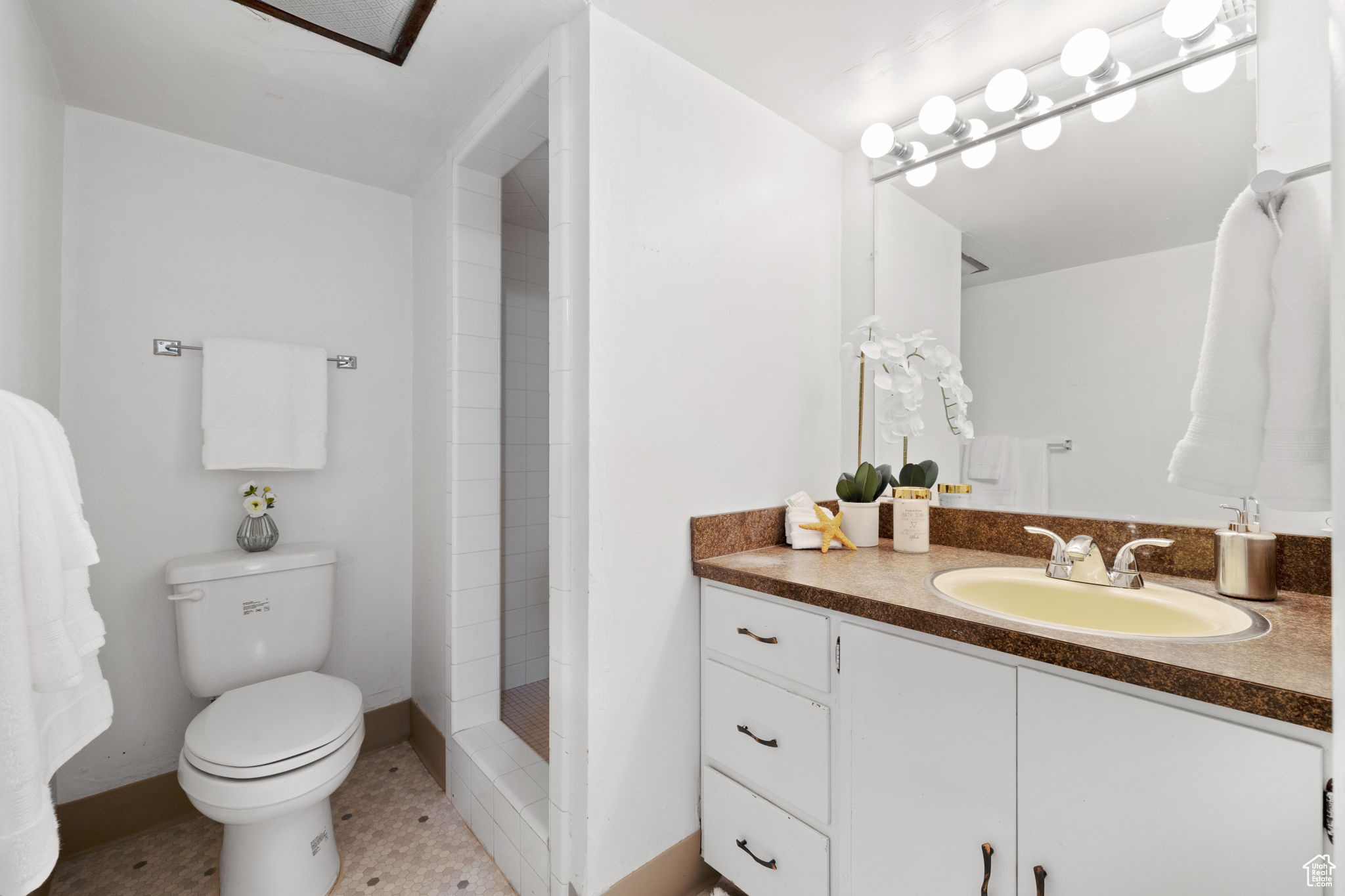 Bathroom with tile floors, vanity, and toilet