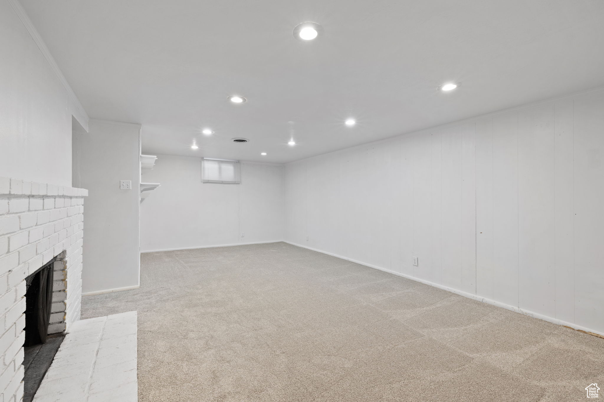 Unfurnished living room with carpet floors and a fireplace