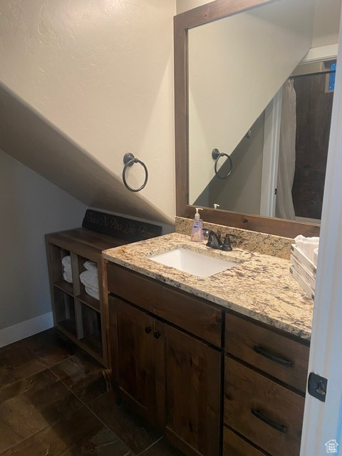 DOWNSTAIRS Bathroom with tile flooring and large vanity