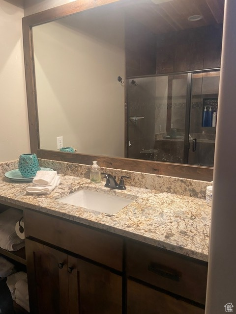 MASTER Bathroom featuring a shower with shower door and vanity