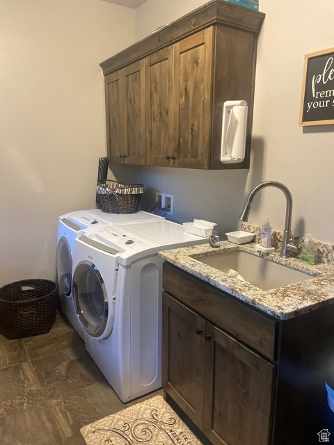 Washroom with washer and dryer, cabinets, tile flooring, washer hookup, and sink