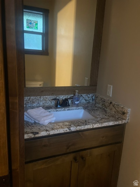 HALF  BATHROOM OFF LAUNDRY ROOM Bathroom featuring vanity and toilet