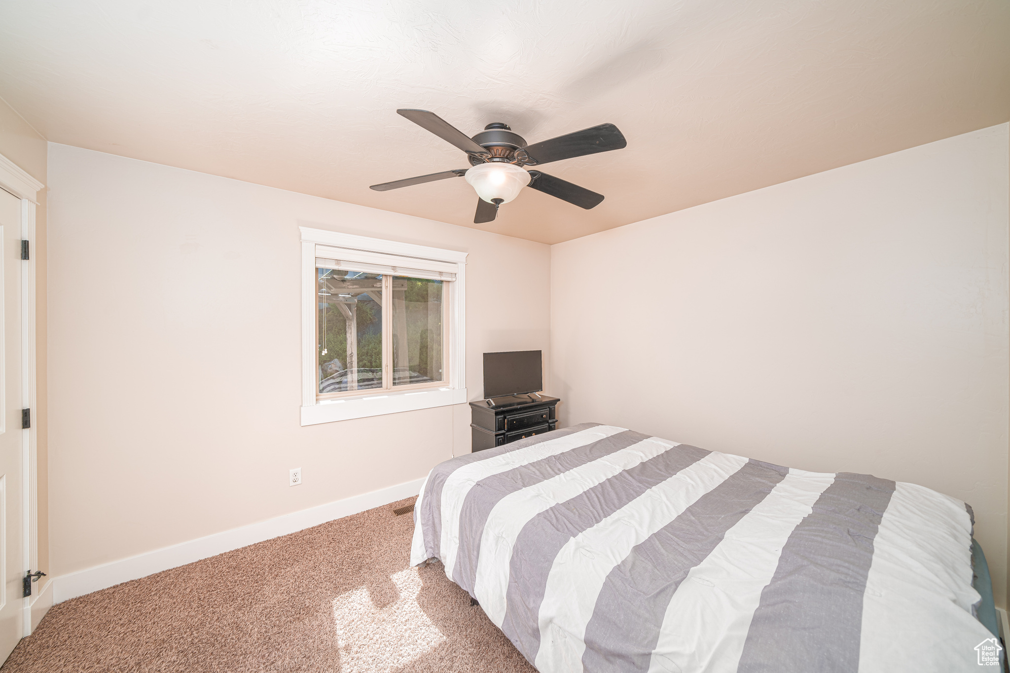 Bedroom featuring carpet floors and ceiling fan