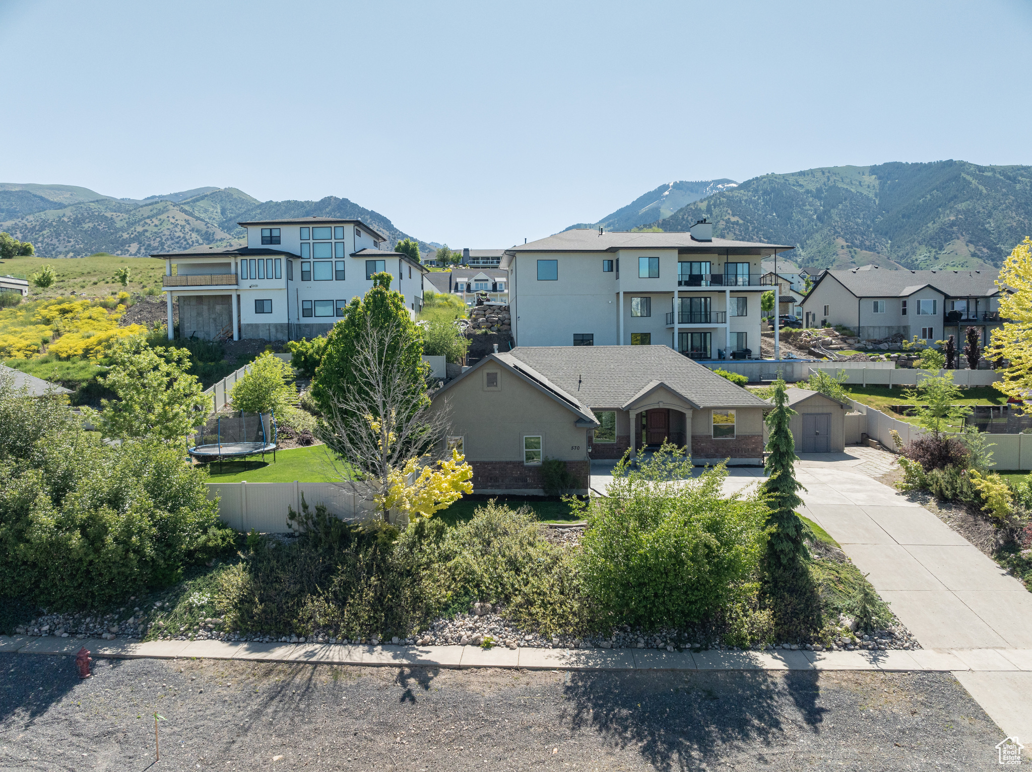 Exterior space with a trampoline, a balcony, a mountain view, and a garage