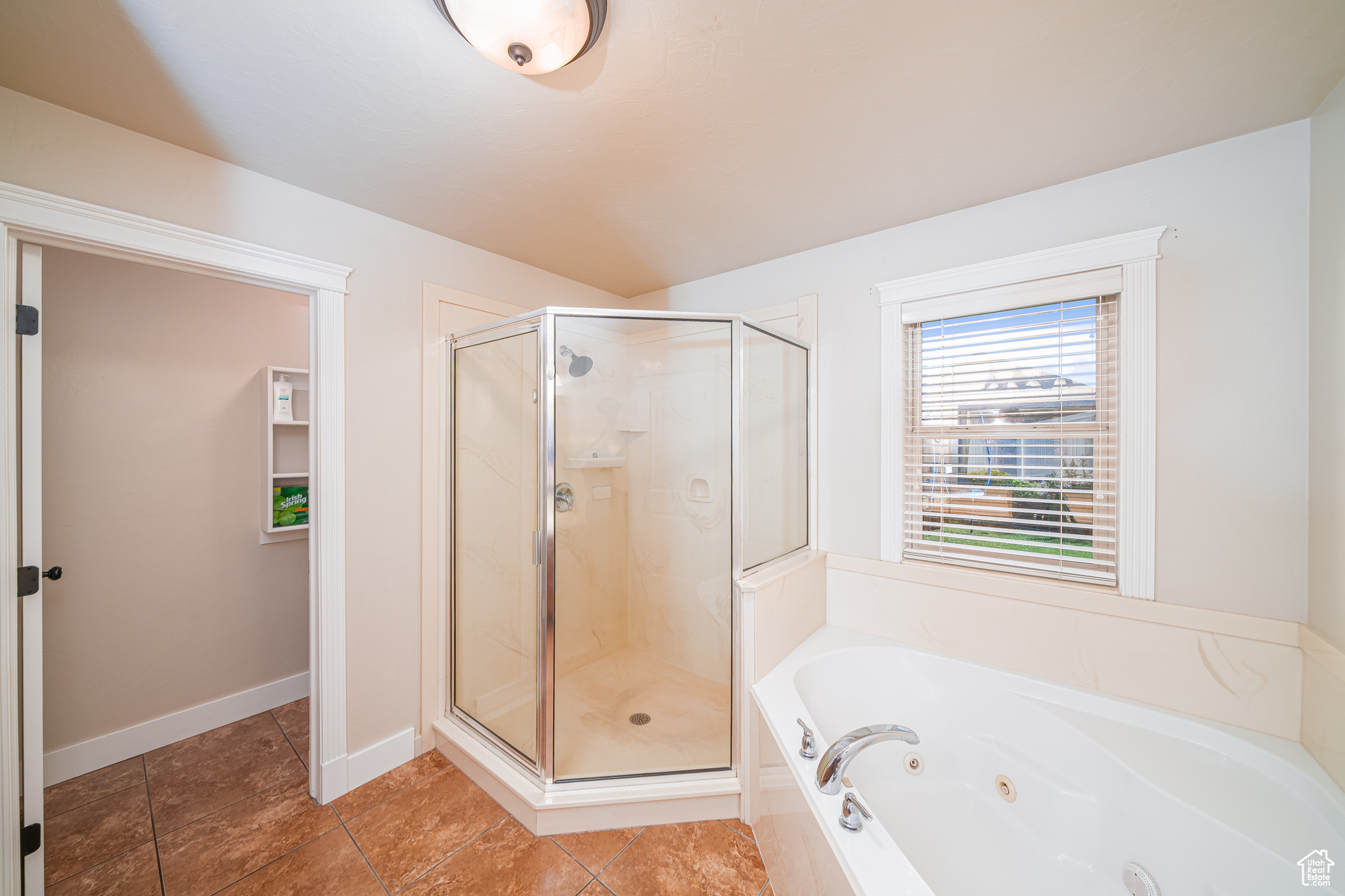 Bathroom featuring tile flooring and independent shower and bath