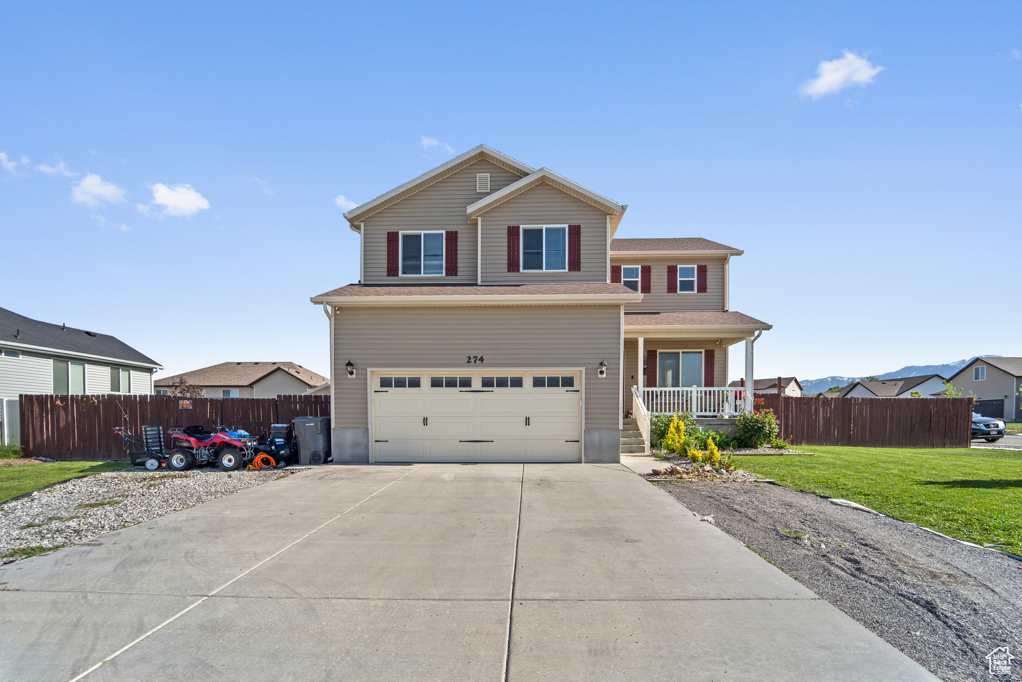 View of front property with a garage and a front lawn